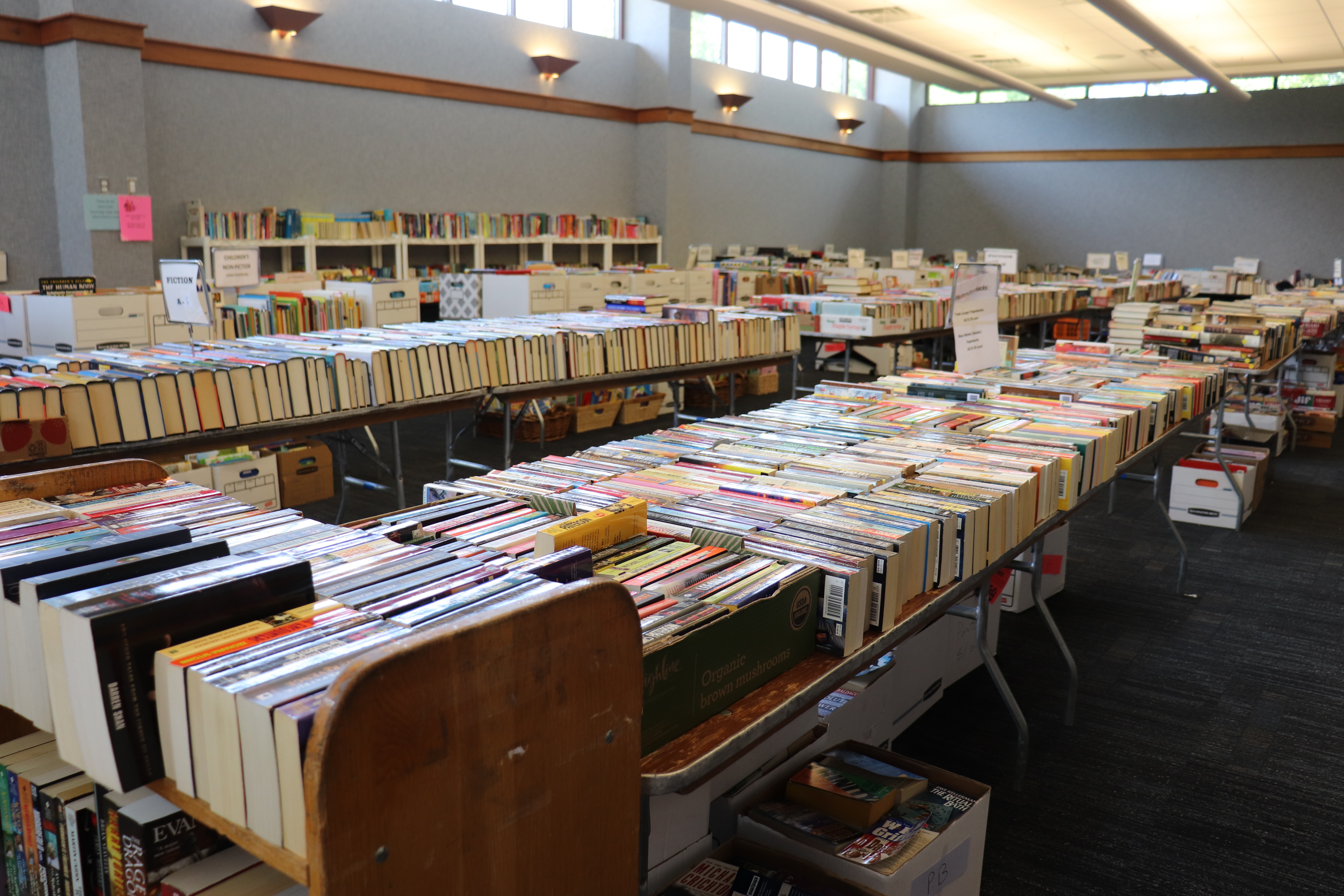 The meeting room filled with books on tables, carts, and shelves