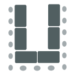 Tables in a u-shape with chairs around the outside