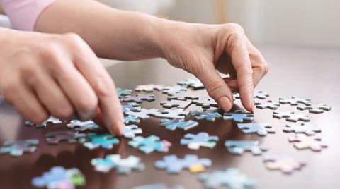 hands doing puzzle