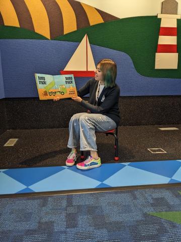 Ms. Mary reading a picture book in the Westacres Activity Center