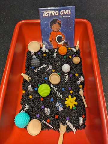 Sensory table with space themed toys inside