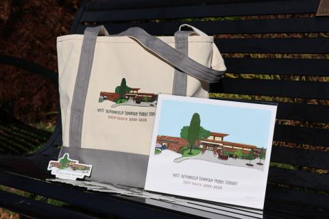 a tote bag, sticker, and print with an illustration of the library