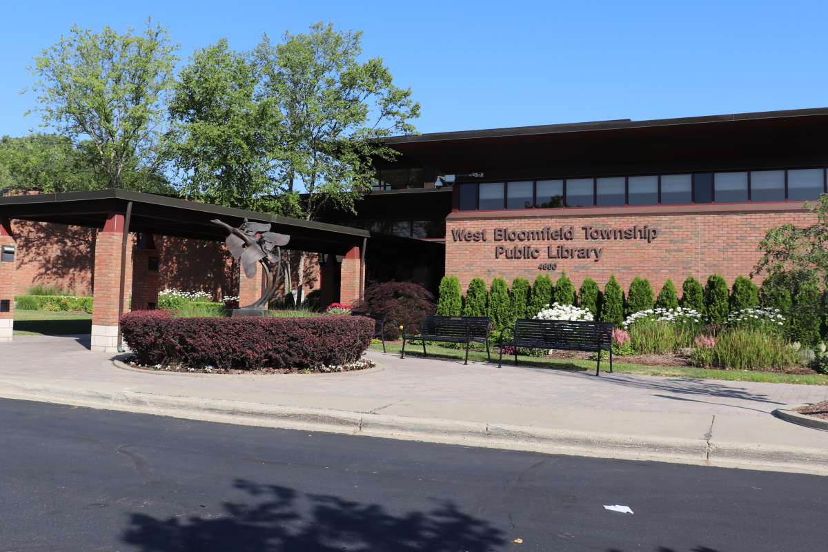 The exterior of the Main Library entry in summer with landscaping in bloom